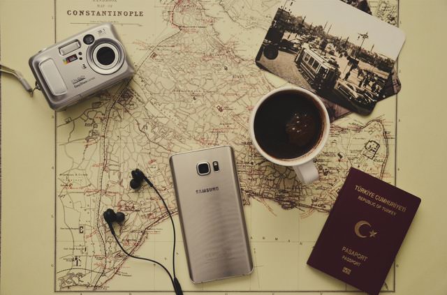 travel map, passport, smartphone, camera, and coffee