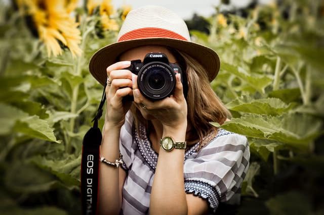 female photographer with a start camera