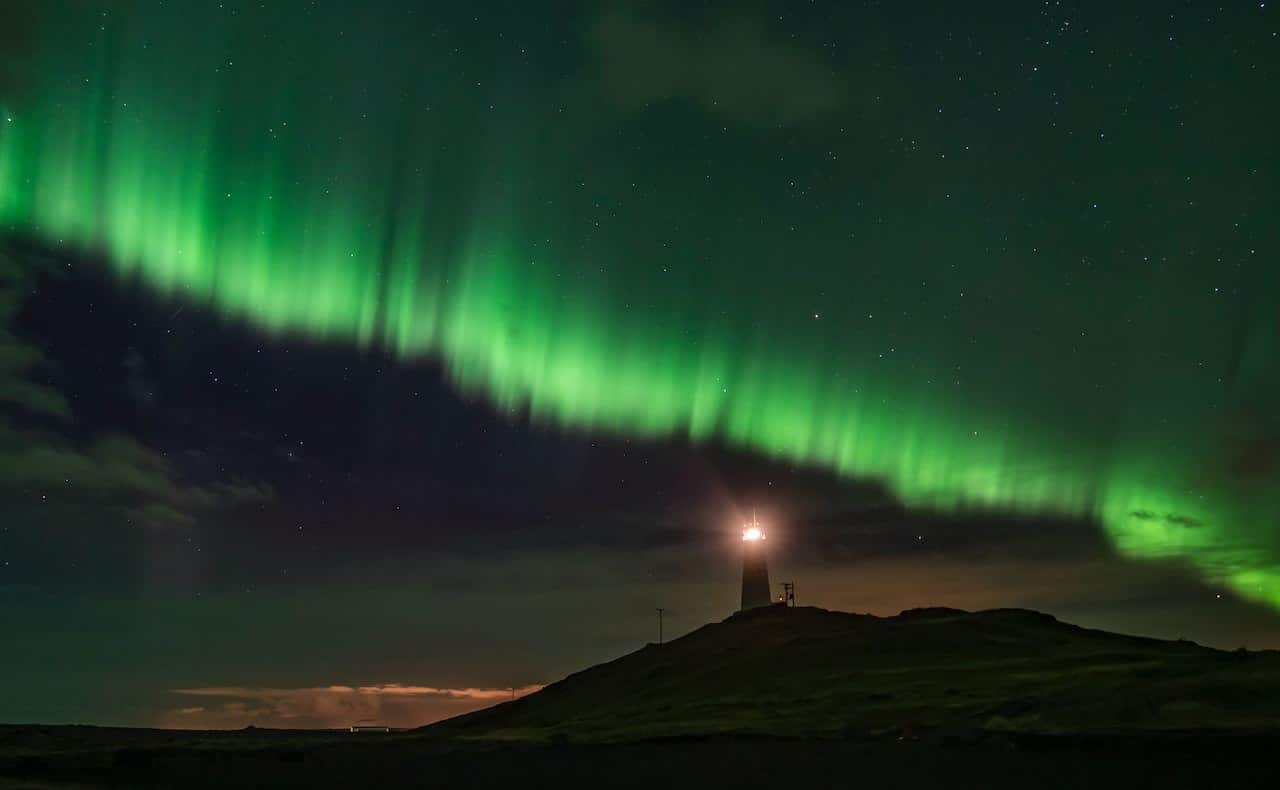 Aurora borealis over lighthouse in Iceland