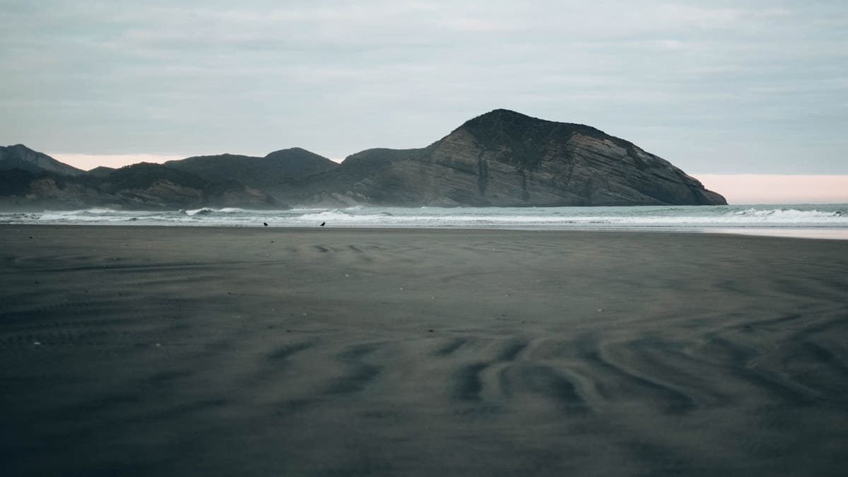 Puponga, New Zealand, landscape photo of beach and mountain