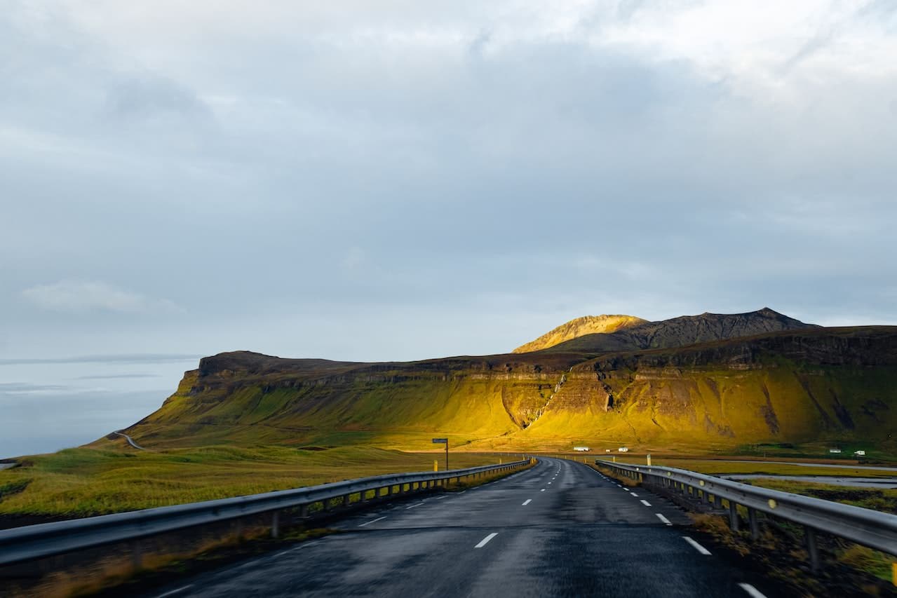 road used as leading lines in landscape photo of hills
